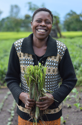 Caroline joyfully holding lemongrass