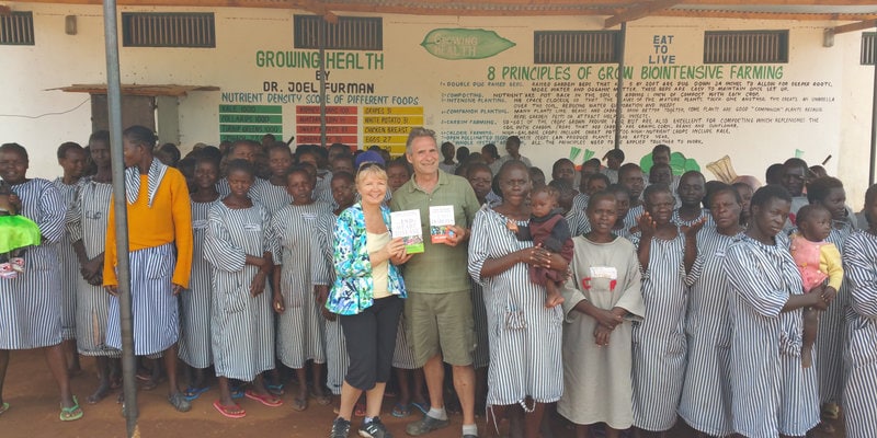 Linda and Dale holding books at prison