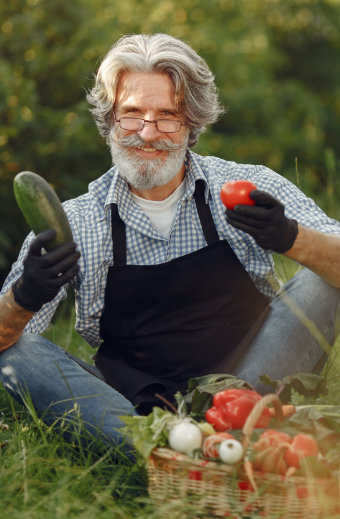 Man holding cuke and tomato